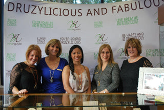 The Nina Nguyen team behind a jewelry display in an archived shop-local photograph.