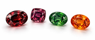 Illustration of red garnet, purple-red rhodolite, green tsavorite and orange spessartine on white