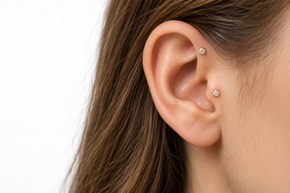 AI-generated illustration of round diamond-style accents at the tragus and forward helix. Styling concept only, not a photograph of a specific product or a fitting recommendation.