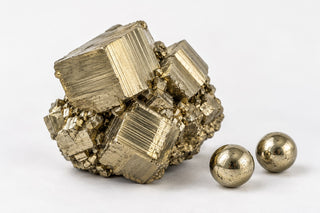Editorial illustration of brassy pyrite cubes and beads