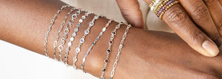 Custom-fit permanent jewelry bracelets in gold and silver at Nina Wynn