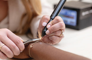 A permanent jewelry bracelet being fitted and welded