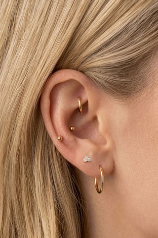Ear with small studs, hoops and a clear-stone accent