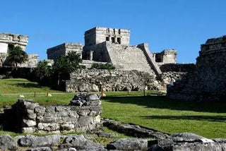 Stone ruins and greenery in an archived photograph from Tulum.
