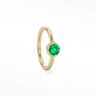 14K yellow gold solitaire seam ring with a round green emerald in a polished bezel setting