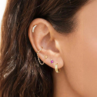 Gold-toned ear cuff with crescent moon design and crystals paired with 14k gold hoop earrings florentine diamond