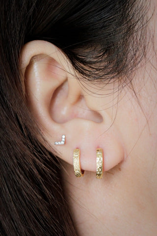14k gold hoop earrings with textured florentine finish and diamond-encrusted l-shaped stud by Wynning reversible hoops