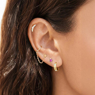Gold-toned ear cuff with crescent moon design and crystals paired with 14k gold hoop earrings florentine diamond