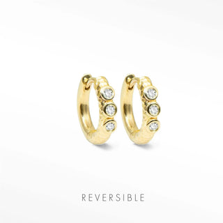 Telletubies 14k gold hoop earrings feature textured gold hoops with four clear round stones as fine jewelry