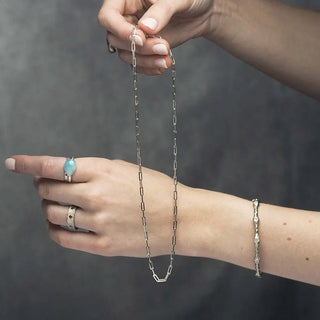 A delicate baby paperclip silver necklace with sleek rectangular links in 18 inch silver chain design