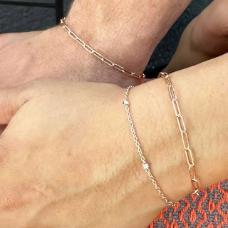 Two matching rose gold paperclip bracelets with delicate chain and diamond accents book permanent jewelry nina wynn appointment