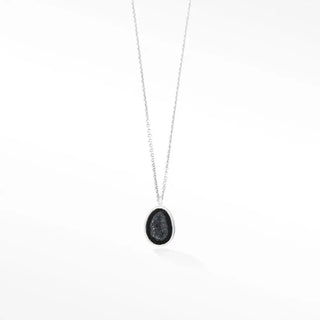 Silver necklace adorn petite geode featuring an oval pendant with dark glittering druzy stone in metal frame