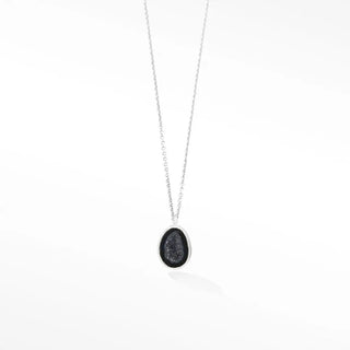Silver necklace adorn petite geode featuring an oval pendant with dark glittering druzy stone in metal frame
