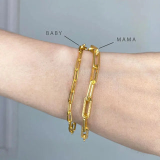 Gold-toned baby paperclip gold vermeil bracelet and mama paperclip gold vermeil bracelet worn together on wrist
