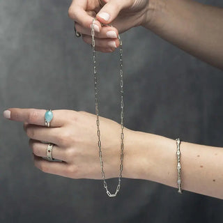 A delicate baby paperclip silver necklace with sleek rectangular links in 18 inch silver chain design
