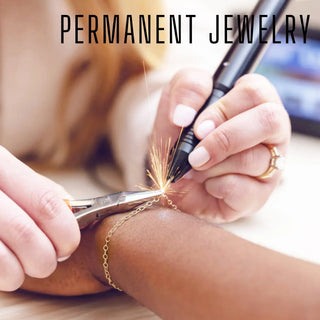 Gold chain bracelet being engraved with a permanent pen for a bespoke jewelry experience gift