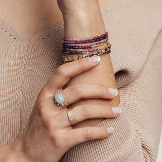 Detailed view of the Bianca Cigar Band Ring in solid 14K yellow gold. The 7mm statement ring showcases a unique scratched texture embedded with mixed-size brilliant-cut diamonds scattered like a starry night.