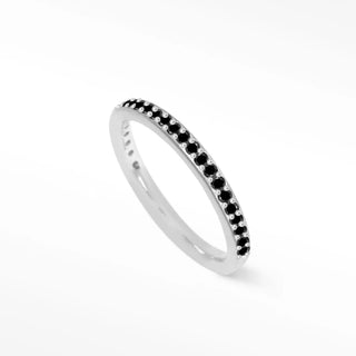 A sleek silver white gold ring featuring a continuous line of small black diamond 14k stones in a pave design