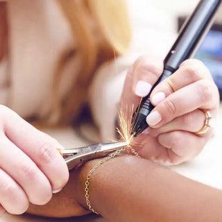 The "spark" moment of getting a permanent bracelet zapped at Nina Wynn's Denver studio.