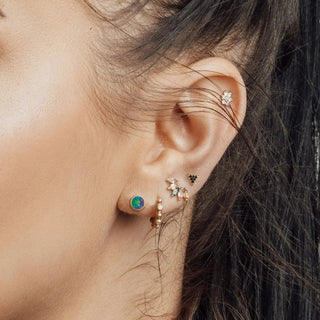 Delicate rose gold cartilage hoop earring with vibrant iridescent opal stone from book ear curation denver nina wynn