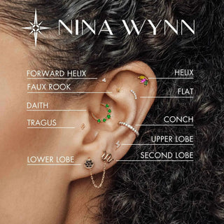 Nina Wynn Book Ear Curation Denver featuring 14k yellow gold cartilage hoop earring with green gemstone and snake dangle