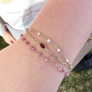 Gold-toned bracelet with teardrop red gemstone and pink white beads book permanent jewelry with nina wynn appointment