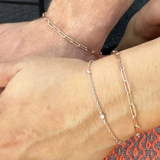 Two matching rose gold paperclip bracelets with delicate chain and diamond accents book permanent jewelry nina wynn appointment