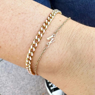 Gold-toned chain bracelet with bold interlocking links and lightning bolt charm available for book permanent jewelry nina wynn appointment in denver permanent jewelry pricing