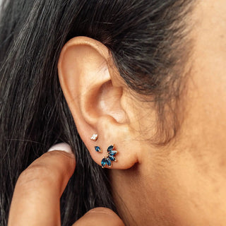 Blue and gold butterfly-shaped stud earrings with faceted gemstones from nina wynn piercing jewelry for ear piercing denver appointment