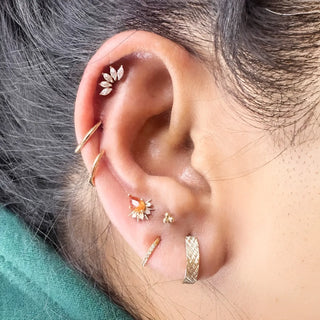Gold-toned leaf-shaped ear piercing with clear crystals intricate design for nina wynn ear piercing denver appointment
