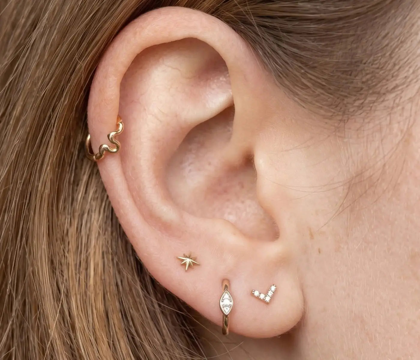 Fine cartilage earrings styled in a curated ear