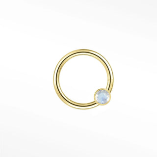 Cartilage hoop earrings in 14k gold with a bezel-set moonstone. Capture luminous ethereal glow for your ear stack