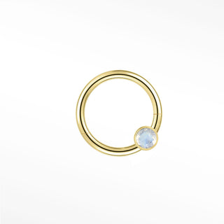Cartilage hoop earrings in 14k gold with a bezel-set moonstone. Capture luminous ethereal glow for your ear stack