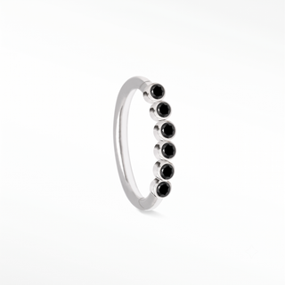 Cartilage hoop earrings showcasing a striking line of bezel-set black diamonds in 14k white gold. Infuse dark modern