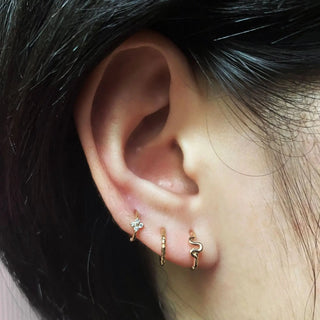 Gold-toned cartilage hoop earring with star textured hoop and coiled snake design in clover small 14k yellow gold