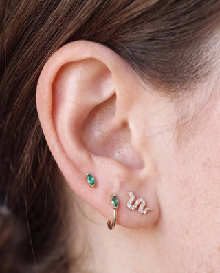 Cartilage hoop earrings featuring a vibrant natural marquise emerald. Handcrafted in 14k gold for secure stable fit