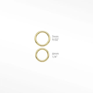 Cartilage hoop earrings featuring a turquoise and diamond evil eye motif in 14k gold. Channel protection vibrant blue
