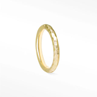 A delicate 14k gold cartilage hoop earring with hammered texture and smooth inner band for comfortable wear