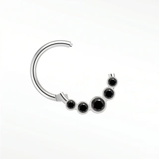 Cartilage hoop earrings featuring a bold sunburst of five bezel-set black diamonds in 14k white gold. Introduce dark