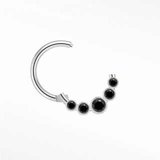Cartilage hoop earrings featuring a bold sunburst of five bezel-set black diamonds in 14k white gold. Introduce dark
