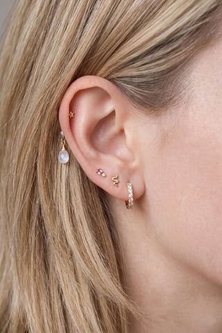 Ear charm crafted in solid 14k gold featuring a lustrous natural pearl and faceted moonstone briolette. Upgrade
