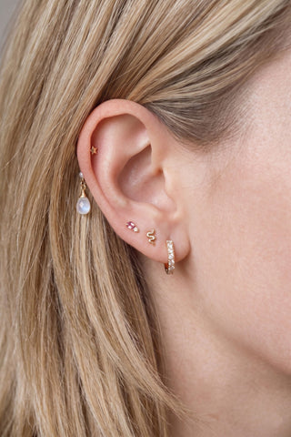 Ear charm crafted in solid 14k gold featuring a lustrous natural pearl and faceted moonstone briolette. Upgrade
