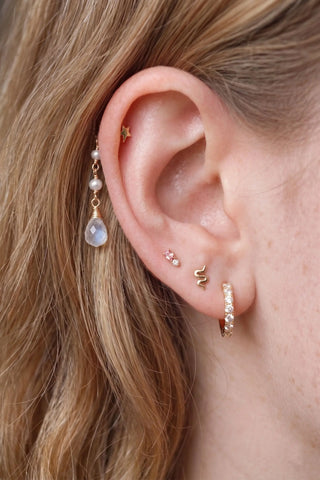 Ear charm crafted in solid 14k gold featuring a beautiful cascade of two natural pearls and faceted moonstone