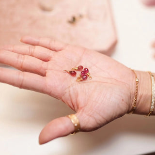 Ear charms crafted in solid 14k gold featuring a faceted pink tourmaline briolette drop. Easily slide onto