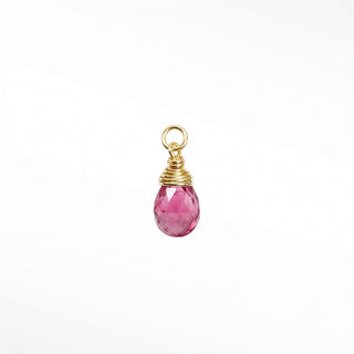 Ear charms crafted in solid 14k gold featuring a faceted pink tourmaline briolette drop. Easily slide onto