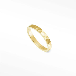 A sleek gold 14k gold gia cigar band ring with hammered texture and polished inner band
