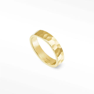A sleek gold 14k gold gia cigar band ring with hammered texture and polished inner surface