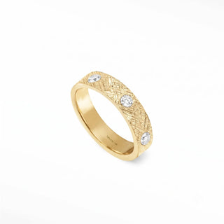 Delicate 14k gold cigar band ring featuring a textured woven pattern and four small round band ring diamonds
