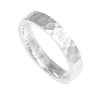 A sleek silver cigar band ring with distinctive hammered texture in hammer sterling silver finish