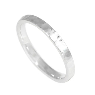A sleek hammered silver band ring hammer sterling silver with a minimalist cigar band ring design